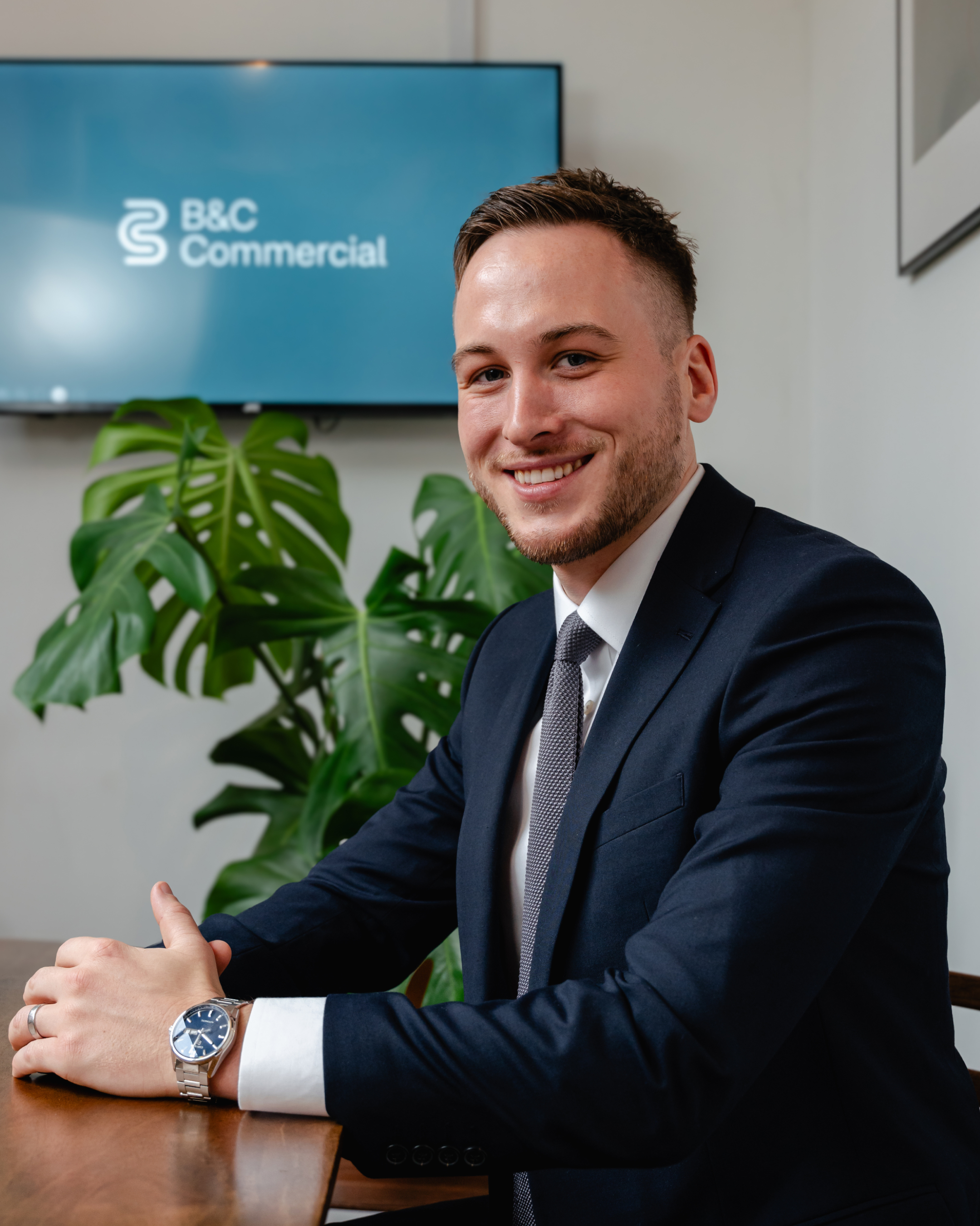 Ben Leonard wearing smart clothes against a plain background