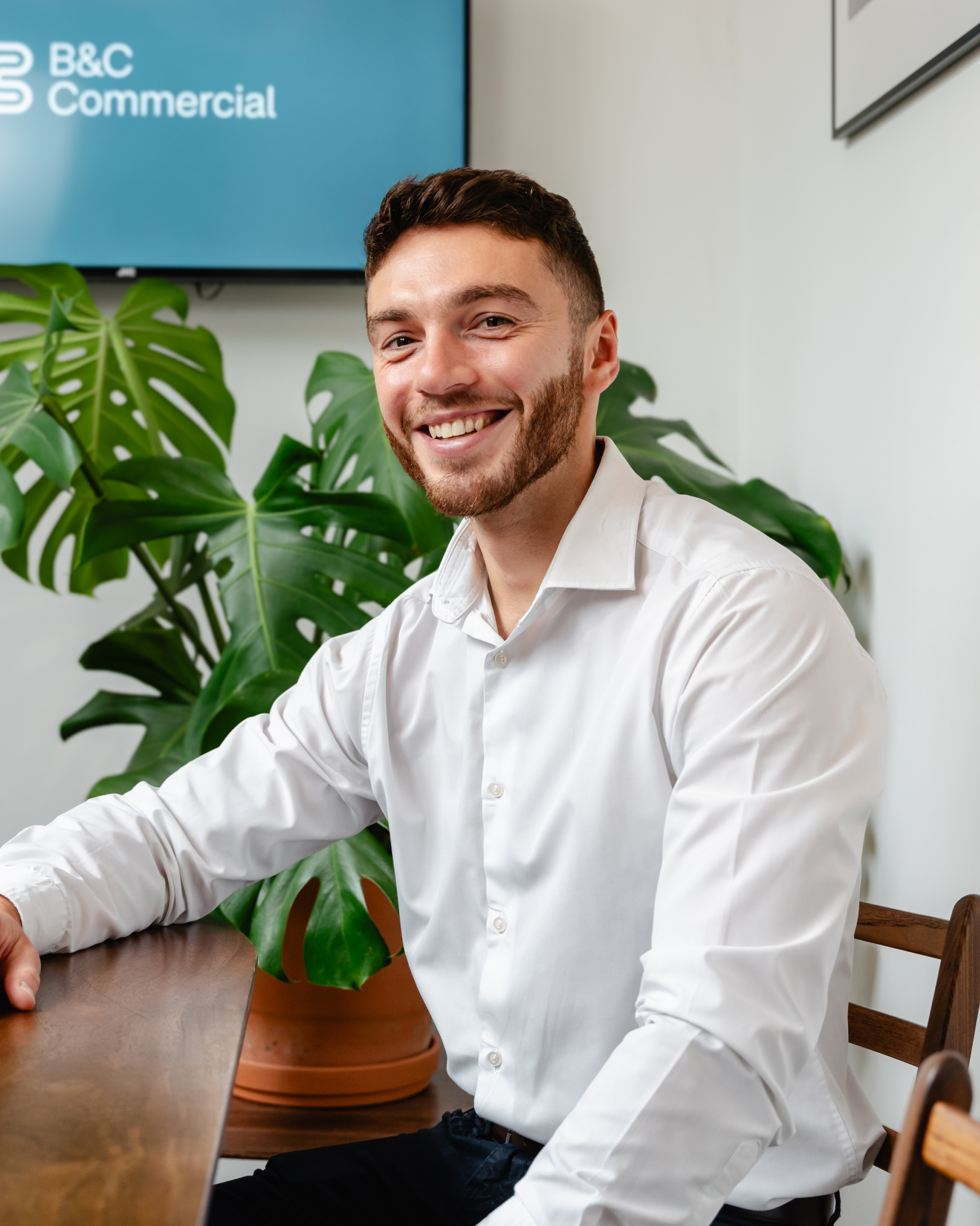 Blaine Rowan wearing smart clothes against a plain background