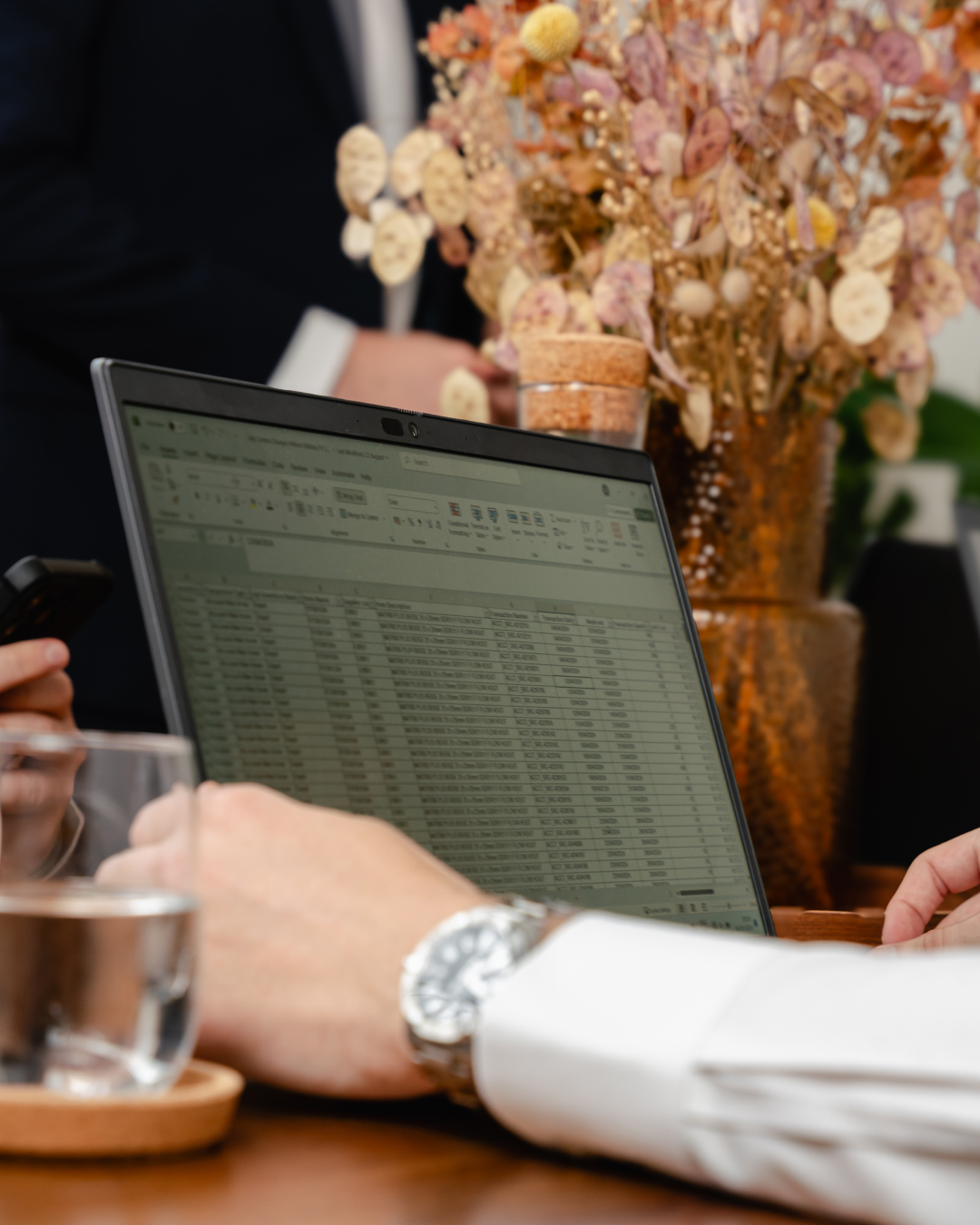 Someone using a laptop computer with a table on it.,